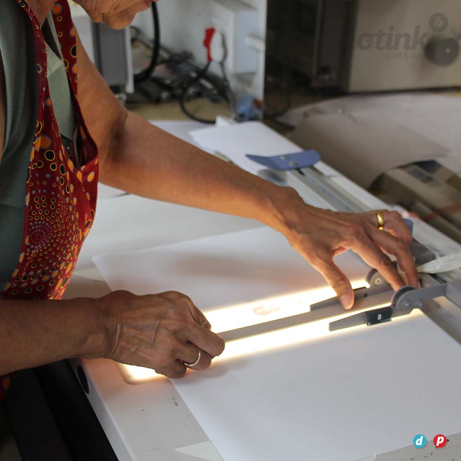 a lady lining up book covers for binding