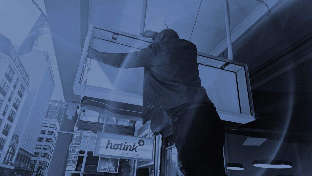 man installing a lightbox