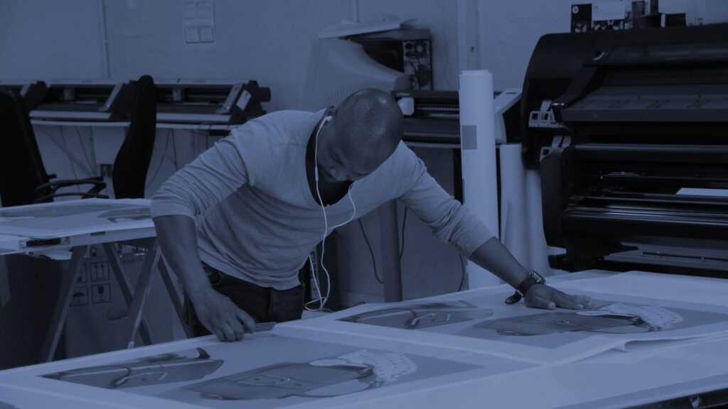 a man applying vinyl to a board