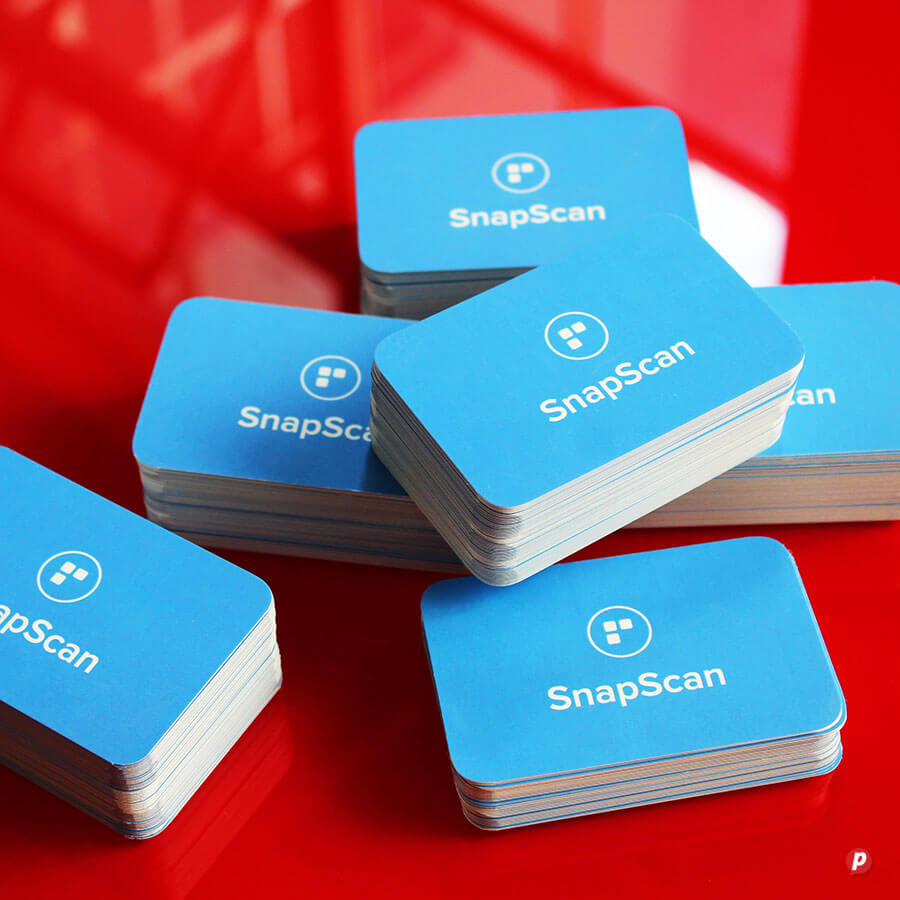 SnapScan contactless payment cards stacked on a red surface, representing digital payment technology.