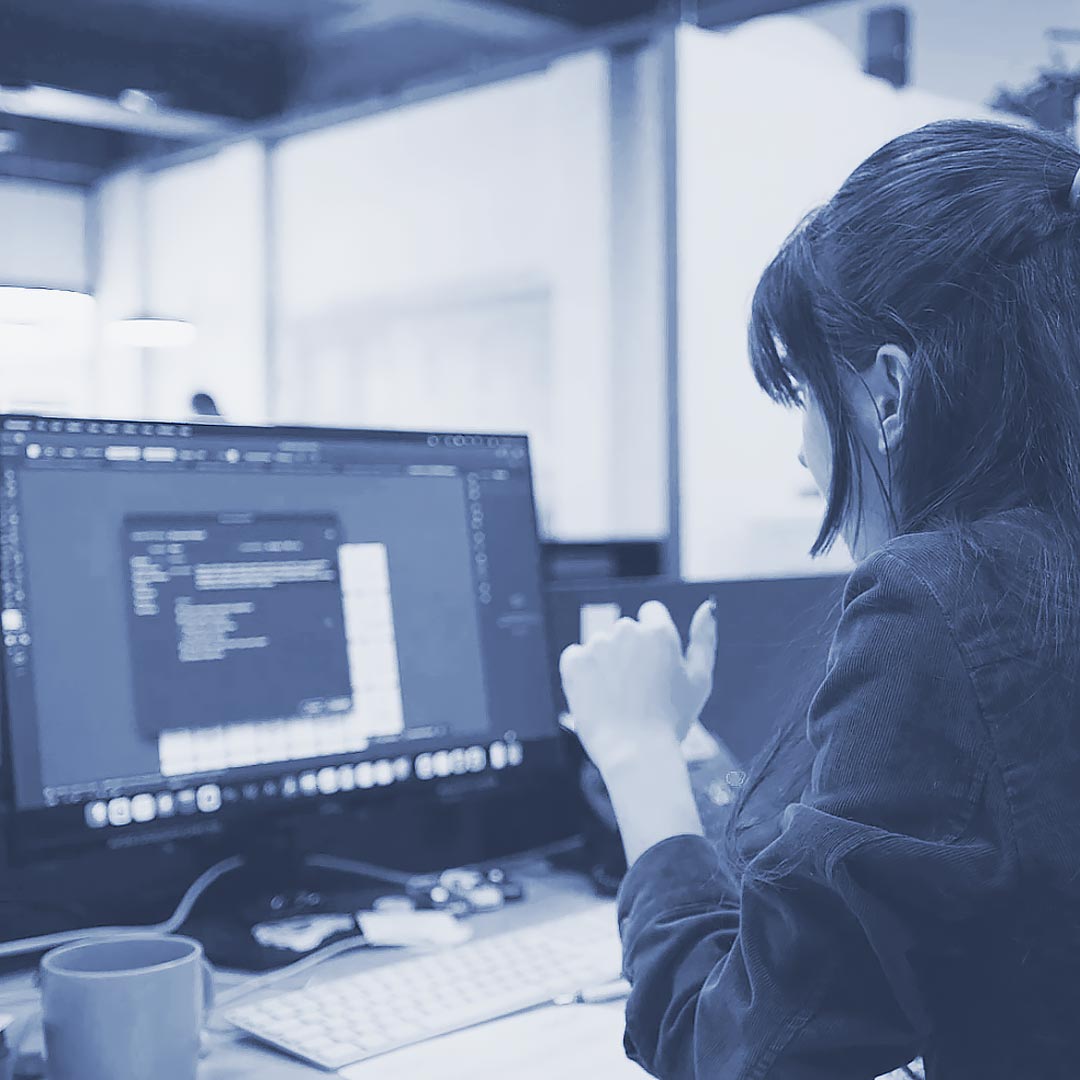 Creative digital artist working on a graphic design project at a modern workspace.