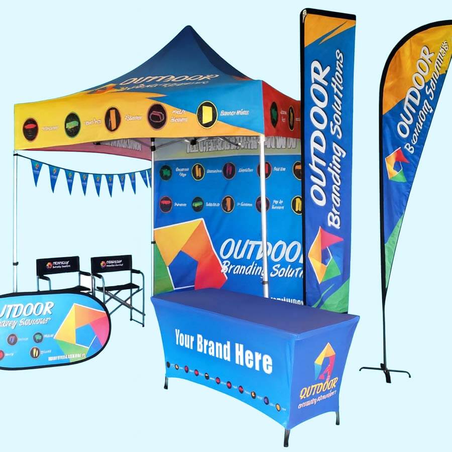Bright outdoor branding display setup with tent, banners, and table for promotional events. Perfect.