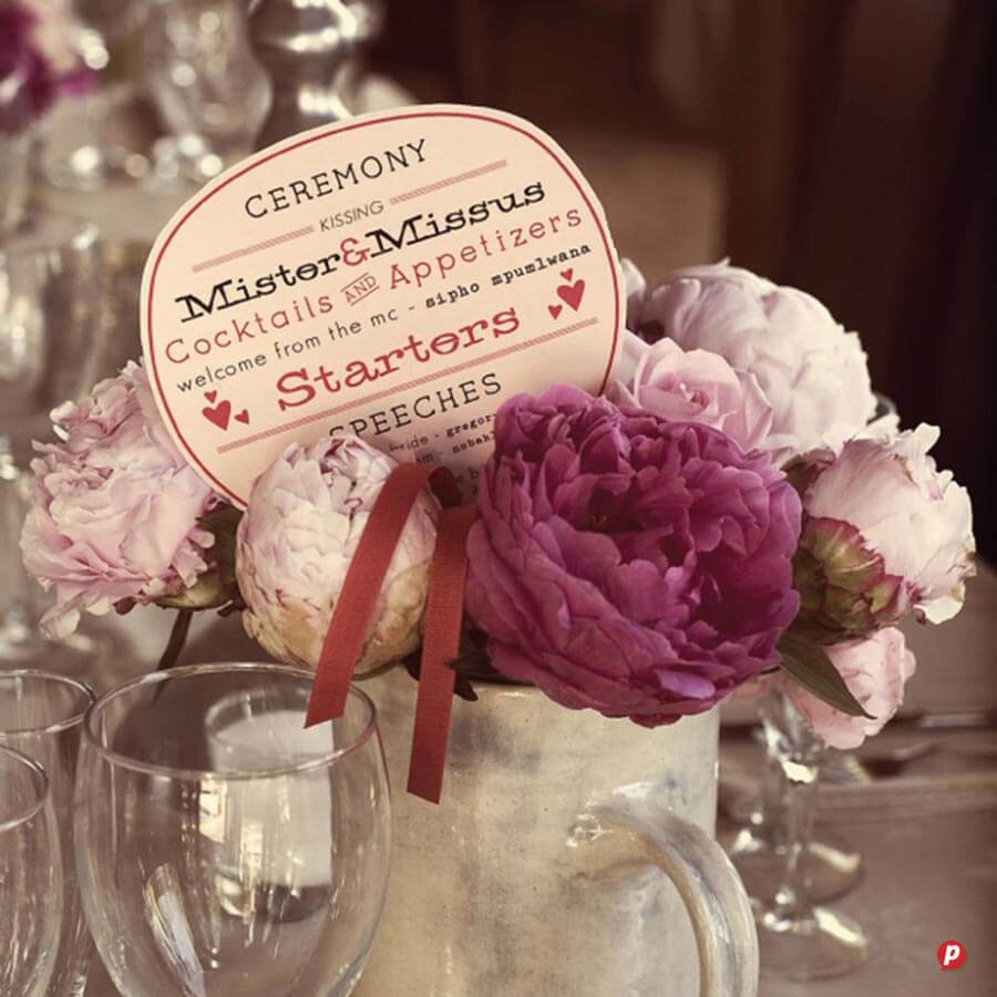 Elegant floral arrangement with pink and white peonies, featuring a wedding-themed sign for Mister &.